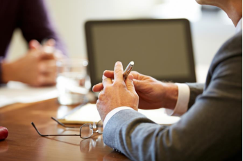 Financial Avisors hands on a conference table